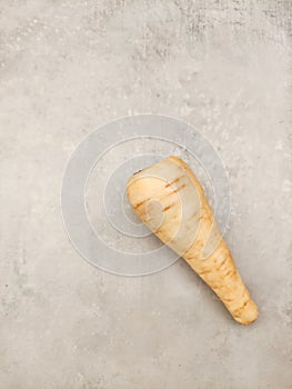 Parsnip lying on gray kitchen countertop ready for cooking copy space preparing vegetables for making soup
