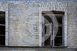 Part of abandoned building with two broken windows