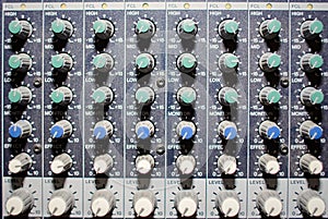 Part of an audio sound mixer with buttons and sliders