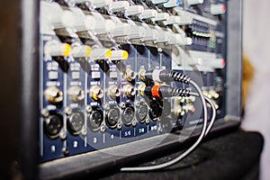 Part of an audio sound mixer with buttons and sliders