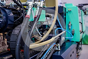 Part of automatic injection molding machine and plastic hoses at exhibition