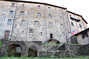 Part of the back of a large and historic stone house in San Romano in Garfagnana with laundry hanging to dry.