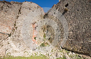 Part of the bastion of an ancient castle. Powerful fortification in the middle of the castle. High ancient walls in the castle.