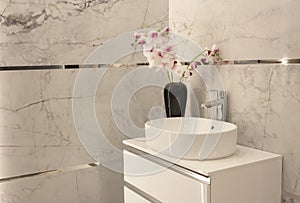 Part of the bathroom with a view of the washbasin with a tap.