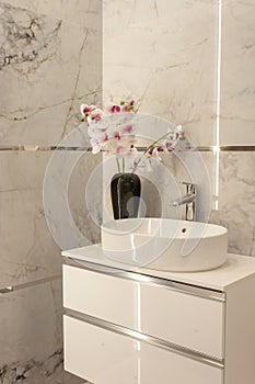 Part of the bathroom with a view of the washbasin with a tap.