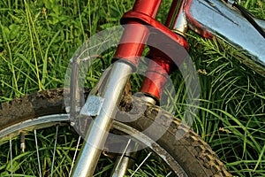 Part of a bicycle with an iron frame and a wheel