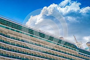 Part of big cruise liner in sea at sunny day.