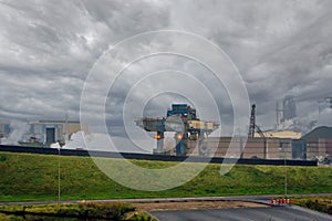 Part of the blast furnace factories against a dramatic sky.