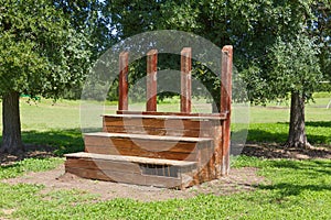 Part of a bleacher at the edge of a field