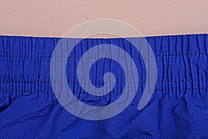 Part of blue sweatpants made of crumpled fabric