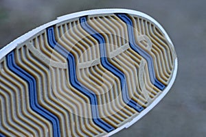 Part of the boot with a rubber sole with a brown and blue pattern