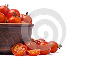 Part of bowl with cherry tomatoes on white background close up