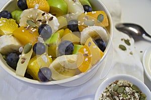 The concept of low-calorie delicious desserts. A bowl of fruit salad. Natural unprocessed organic food. A delicious
