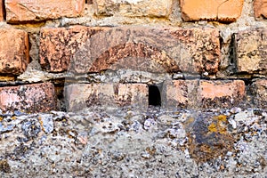 Part of a brick wall on a concrete foundation