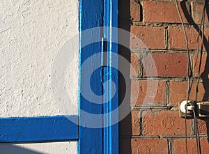 Part of a brick wall and painted door