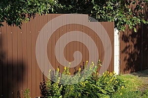 Part of a brown metal fence wall in the street