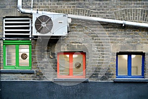 Part of a building facade with small colored windows