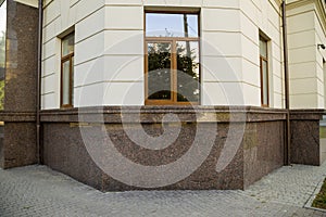 Part of a building facade with the surface of granite wall. Natural stone materials