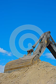 Part of a bulldozer sticking in the sand photo