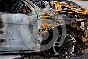 Part of the car after arson in a parking lot near the house. to illustrate an article about fire, banditry, an insured event, loss