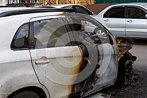 Part of the car after arson in a parking lot near the house. to illustrate an article about fire, banditry, an insured event, loss