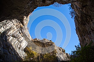 Part of the cave and vibrant blue sky in Prohodna