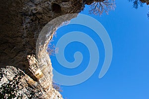 Part of the cave and vibrant blue sky in Prohodna