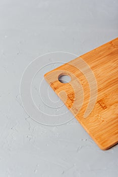 part of a cutting wooden board on a blue background with flour