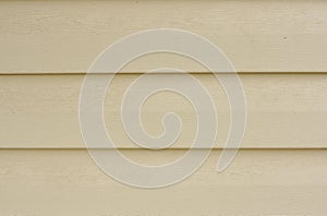 Part of the dusty beige wall.