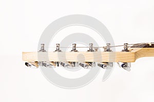 Part of electric guitar headstock against white background.