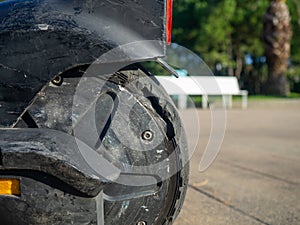 Part of an electric scooter close-up. Broken tire. Broken scooter wheel. Propulsion tool