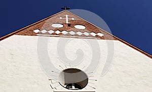 Part of the facade of the Backen church with various Christian symbols