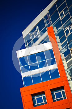 Part of the facade modern building with red and blue