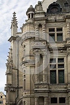 A part of a facade with the windows and columns of the town hall in the French city Arras