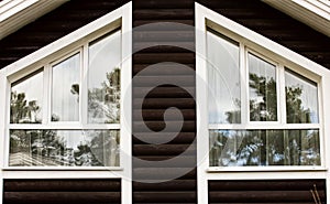 Part of the facade of a wooden house with windows