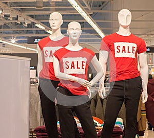 Part of female mannequin dressed in casual clothes with sale text in the shopping department store for shopping, business fashion