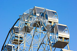 Part of the Ferris wheel against the blue sky