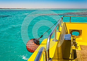 Part of fishing boat with red buoy