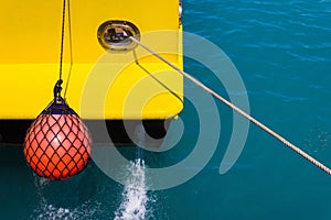 Part of fishing boat with red buoy