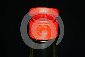 Part of glass bottle with soy sauce with red plastic cap