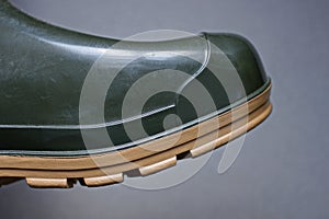 Part of a green rubber boot
