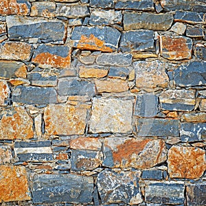 Part of grunge colorful stone blocks wall.