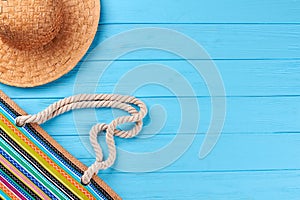 Part of hat and handbag, blue background.