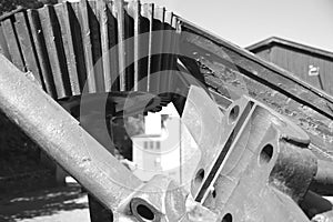 Part of a historical machine with gear in black and white