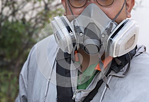 Part of human face in multi-purpose respirator half mask with chemical protective clothing