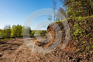 Part of the land cut off by an excavator to widen the passage