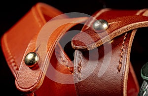 Part of a leather product or belt with a metal rivet