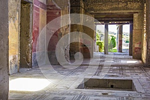 Part of the living room with frescoes painted on the walls in a ruined house in Pompeii, Naples, Italy. The ruins of the ancient c