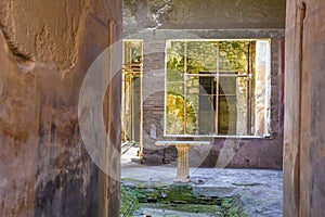 Part of the living room with frescoes painted on the walls in a ruined house in Pompeii, Naples, Italy. The ruins of the ancient c