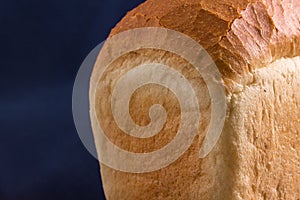 Part of a loaf of white bread on a blue background